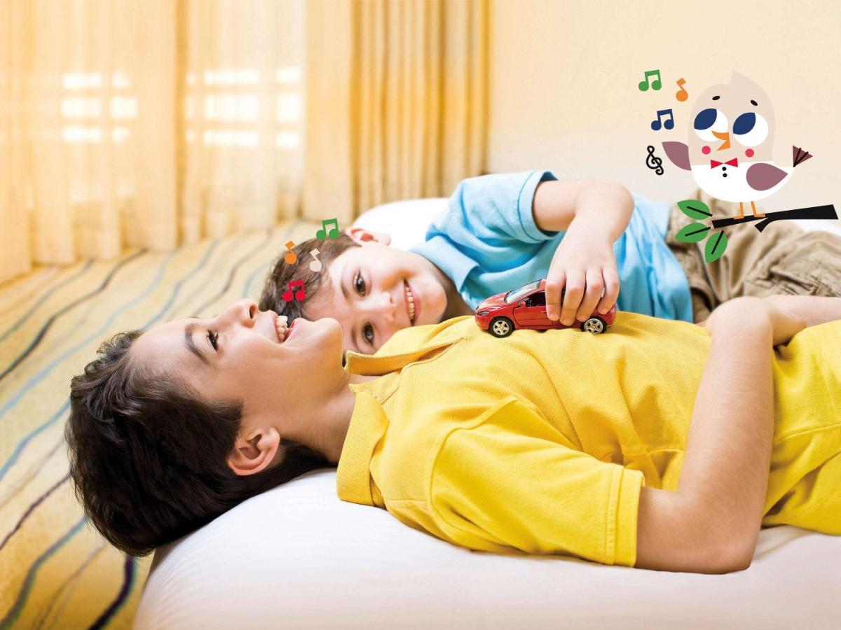 Movenpick Jumeirah Village Triangle دبي المظهر الخارجي الصورة A child with autism playing with a toy car